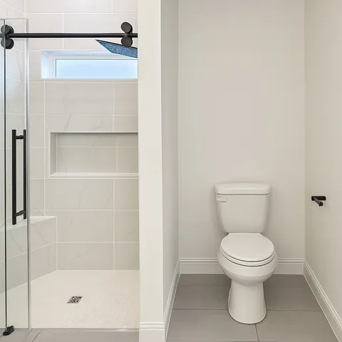 a white toilet sitting next to a bathroom sink