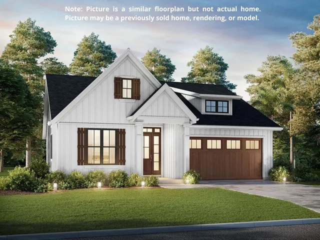 a front view of a house with a yard and potted plants