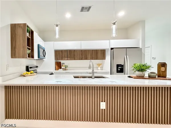 a view of a kitchen with a sink and a chandelier