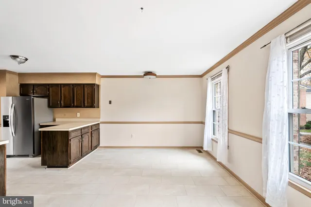 a view of a kitchen with a sink and refrigerator