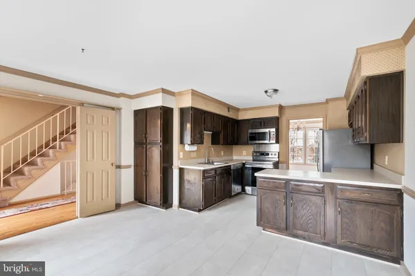 a kitchen with stainless steel appliances a refrigerator and a stove top oven