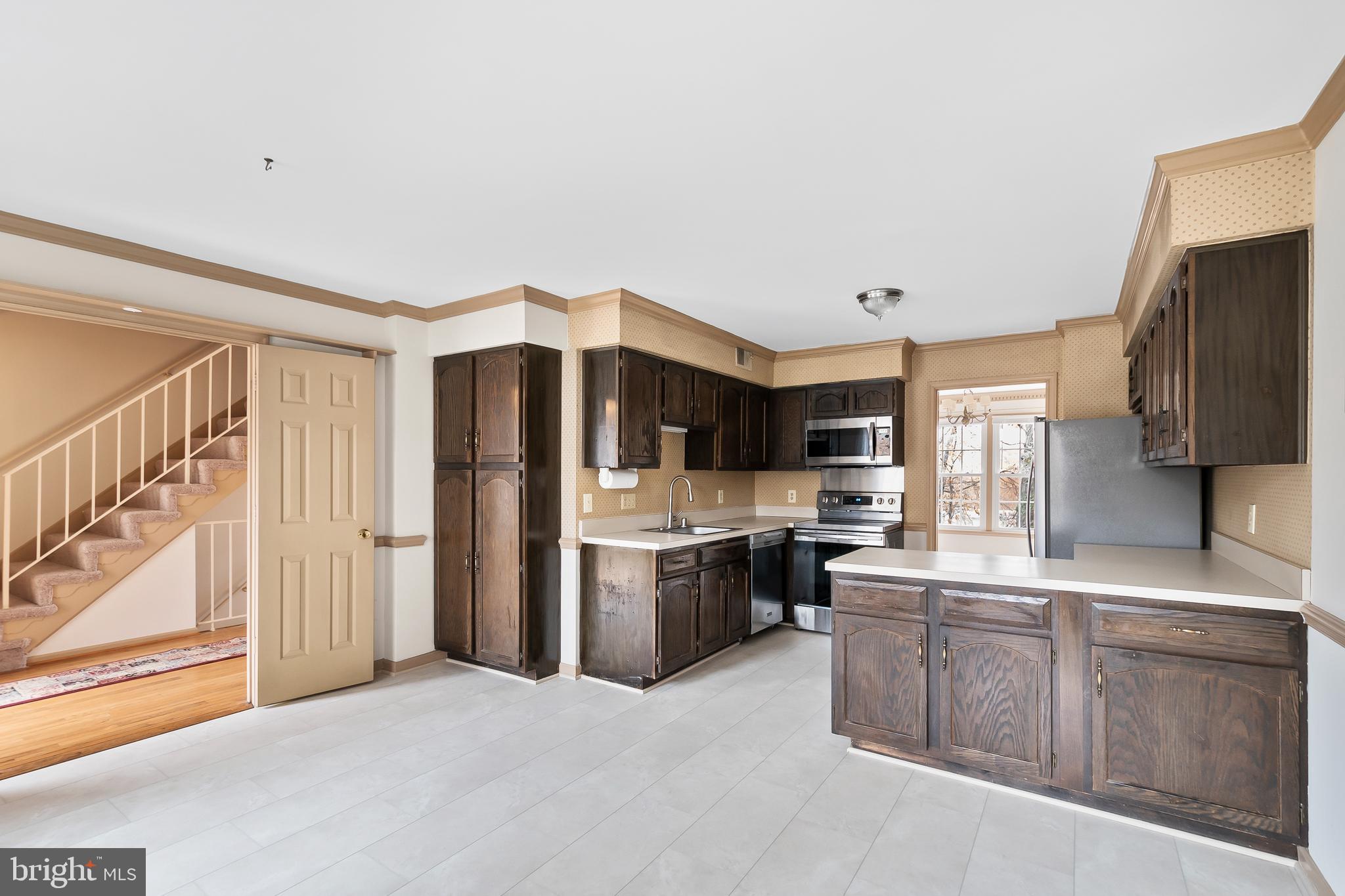9518 Hunt Square Court Springfield, VA 22153 - Photo 15 of 39 a kitchen with stainless steel appliances a refrigerator and a stove top oven
