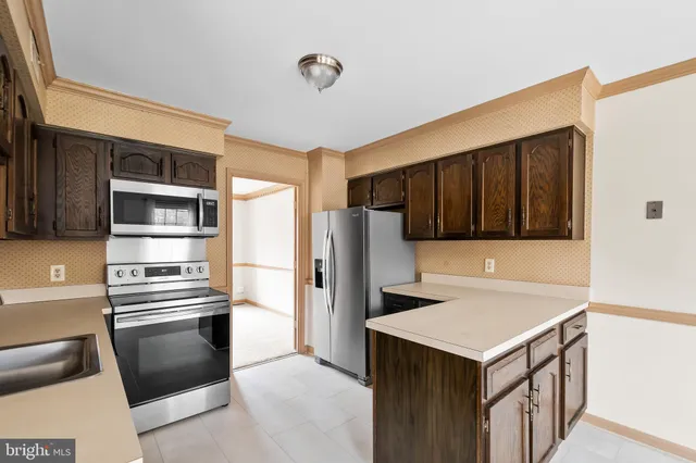 a kitchen with stainless steel appliances a stove a microwave and a refrigerator