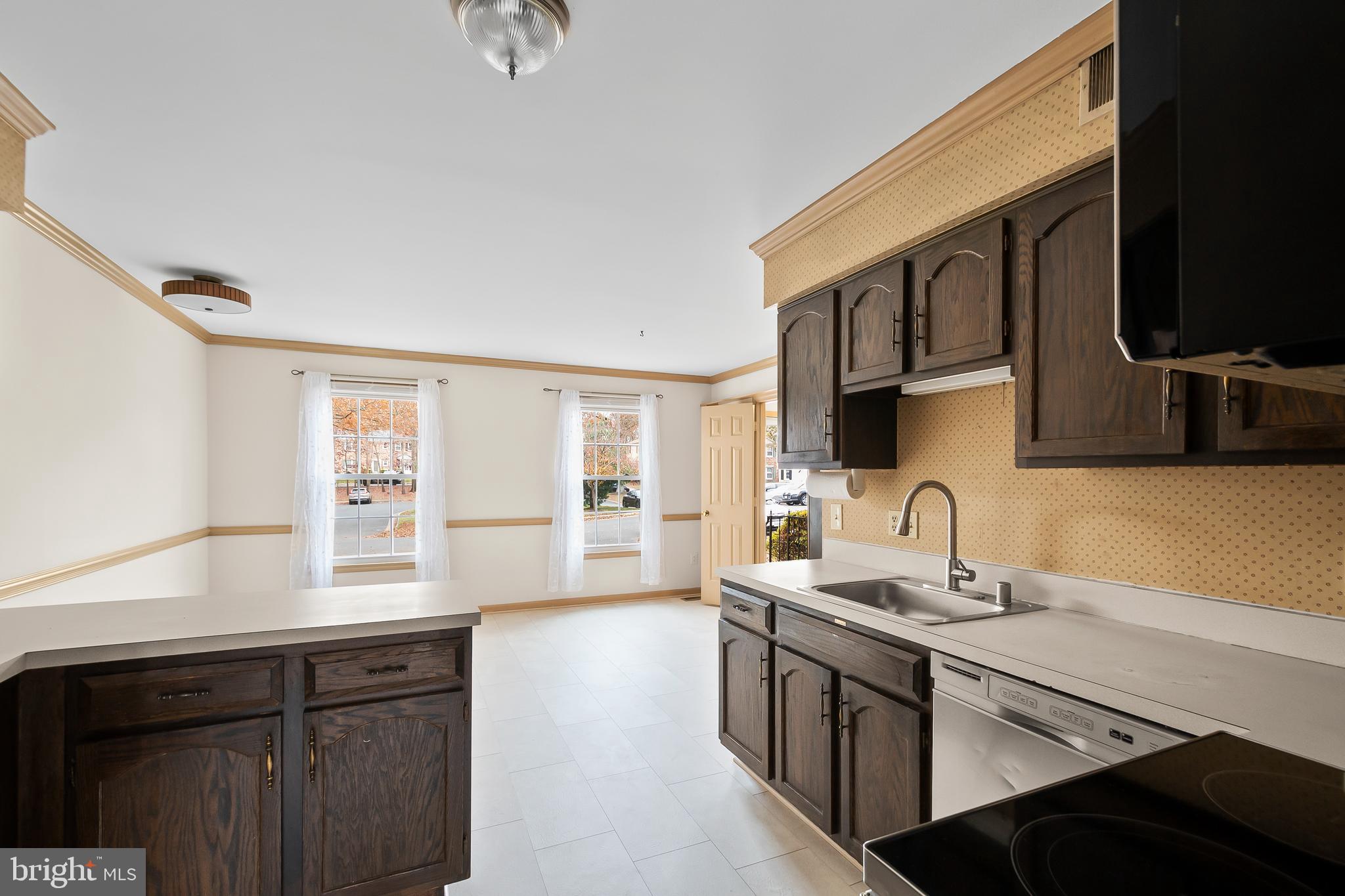 9518 Hunt Square Court Springfield, VA 22153 - Photo 18 of 39 a kitchen with stainless steel appliances granite countertop a sink stove and cabinets