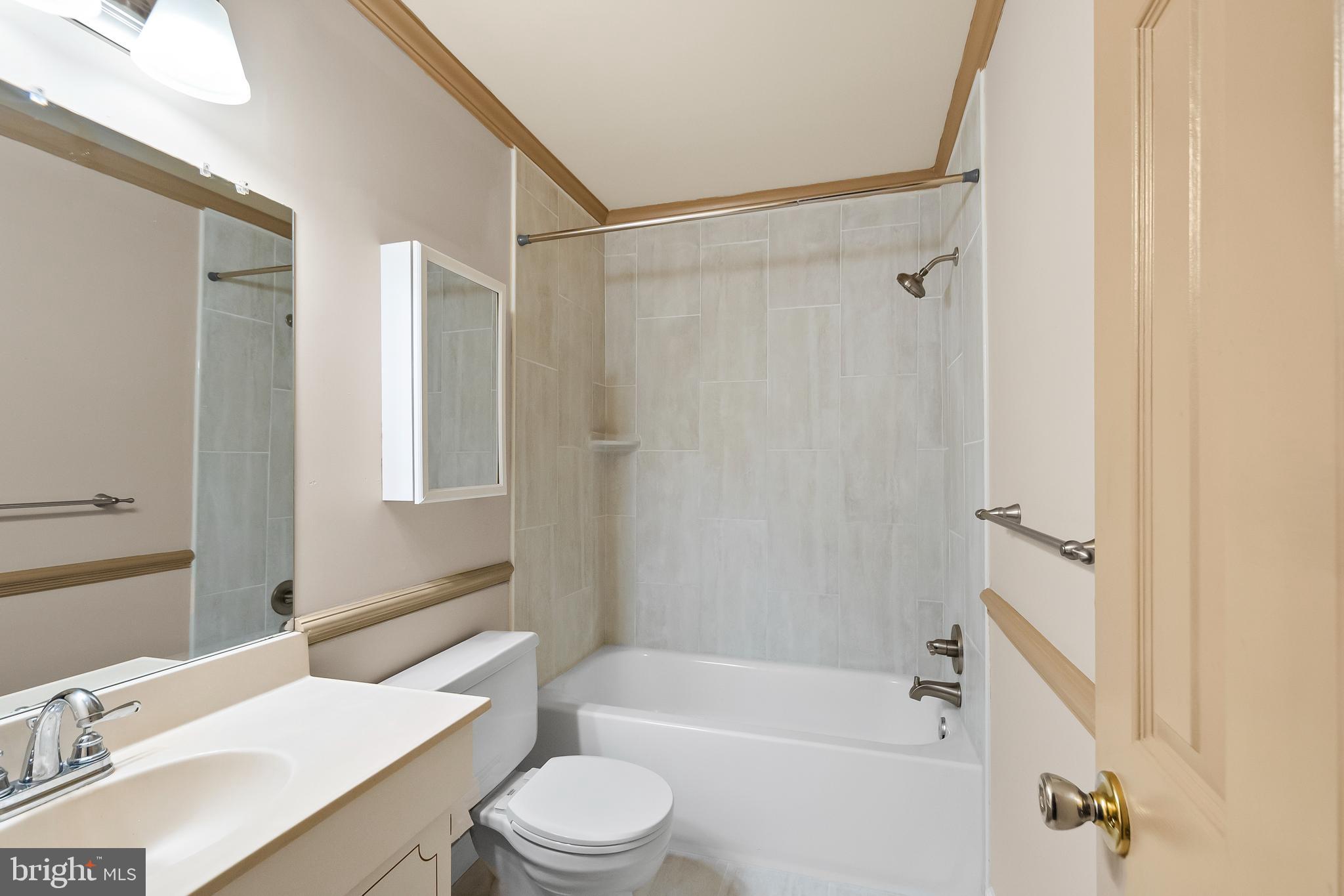 9518 Hunt Square Court Springfield, VA 22153 - Photo 24 of 39 a bathroom with a sink toilet and shower