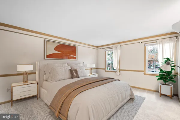a bedroom with a large bed and potted plant