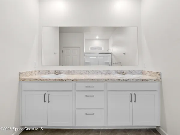 a sign of golf club on a wall under a tree