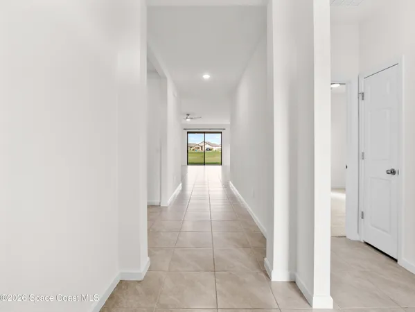 a kitchen with granite countertop a refrigerator a sink a stove a microwave a counter top space and cabinets