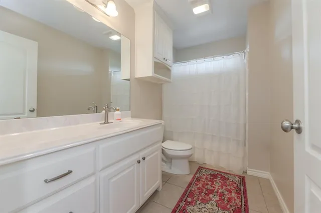 a bathroom with a sink a toilet a shower and a mirror