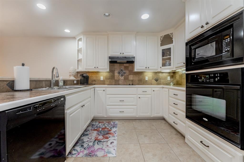 6027 Oakmont Drive Wichita Falls, TX 76310 - Photo 19 of 40 a kitchen with stainless steel appliances granite countertop a stove a sink and a microwave