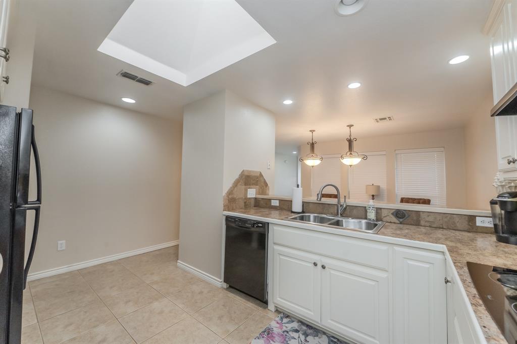 6027 Oakmont Drive Wichita Falls, TX 76310 - Photo 24 of 40 a kitchen with a sink and a refrigerator