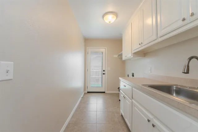 a kitchen with a sink and cabinets
