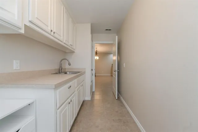 a kitchen with a sink and cabinets