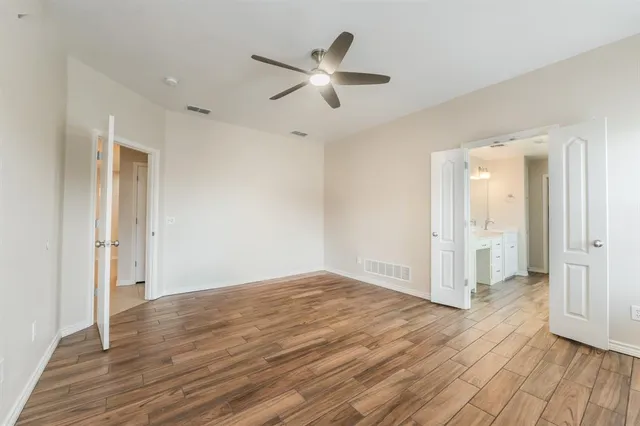 a view of an empty room and wooden floor