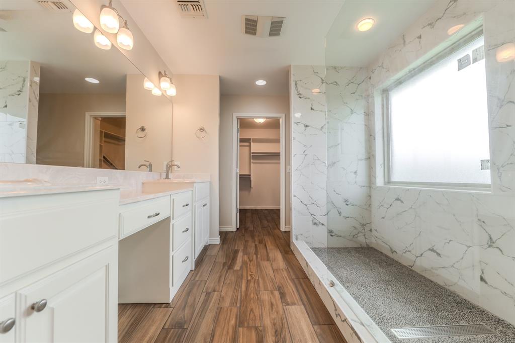 6027 Oakmont Drive Wichita Falls, TX 76310 - Photo 34 of 40 a spacious bathroom with a double vanity sink and a mirror
