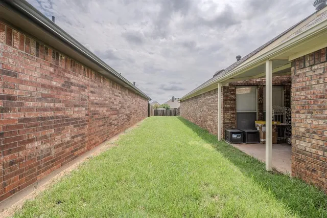 a backyard of a house with barbeque oven