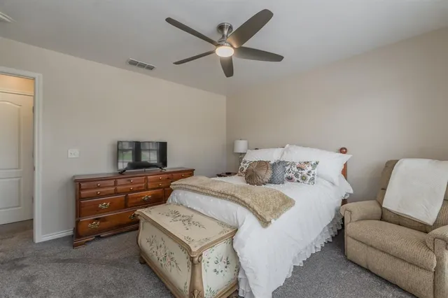 a bedroom with a bed and a couch