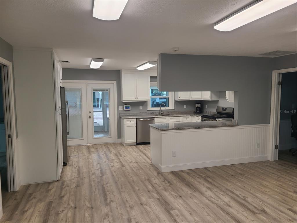 500 Coker Road Fort Pierce, FL 34945 - Photo 3 of 15 a large kitchen with cabinets wooden floor and stainless steel appliances