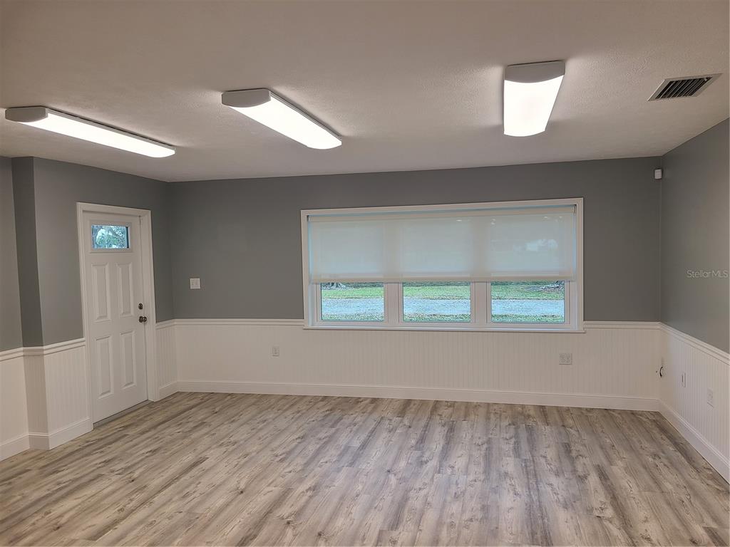 500 Coker Road Fort Pierce, FL 34945 - Photo 5 of 15 wooden floor in an empty room with a window