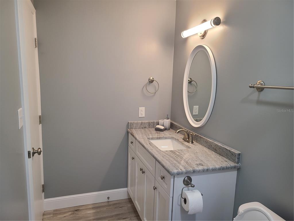500 Coker Road Fort Pierce, FL 34945 - Photo 10 of 15 a bathroom with a granite countertop sink and a mirror