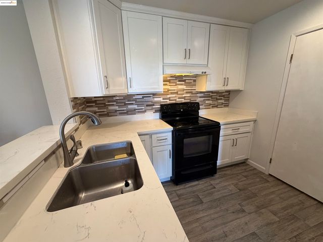 a room with a wooden floor and furniture