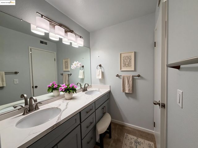 a bathroom with a sink double vanity and a mirror