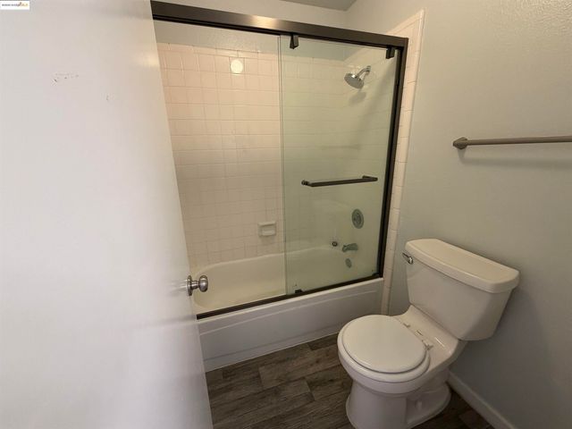 a bathroom with a shower and a toilet