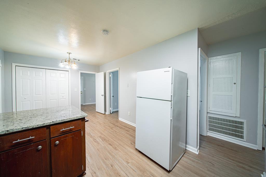 4 Clausen Drive Columbus, GA 31907 - Photo 11 of 27 a kitchen with kitchen island a counter top space wooden floor and appliances