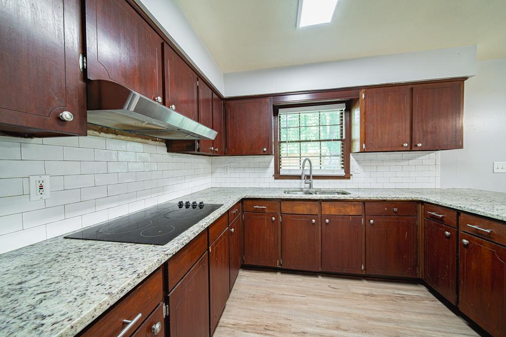 4 Clausen Drive Columbus, GA 31907 - Photo 12 of 27 a kitchen with stainless steel appliances granite countertop a sink a stove and a wooden cabinets