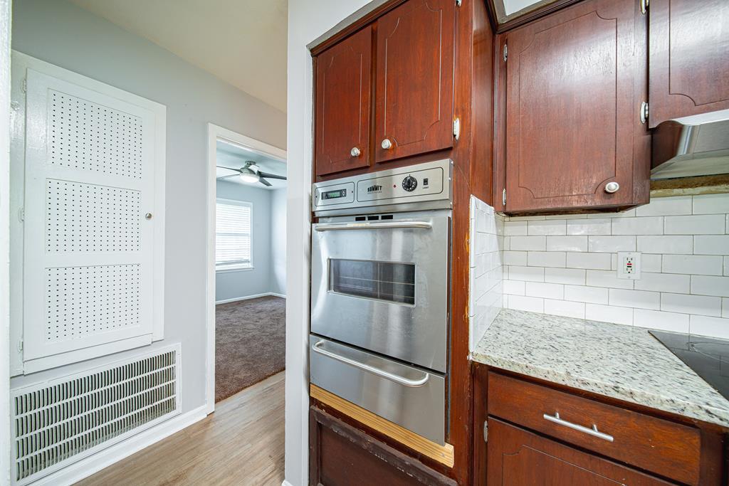 4 Clausen Drive Columbus, GA 31907 - Photo 13 of 27 a kitchen with granite countertop wooden cabinets stainless steel appliances and a counter space