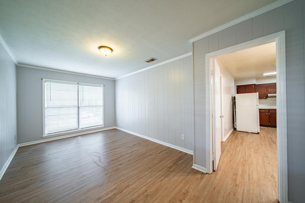 4 Clausen Drive Columbus, GA 31907 - Photo 15 of 27 an empty room with wooden floor and windows