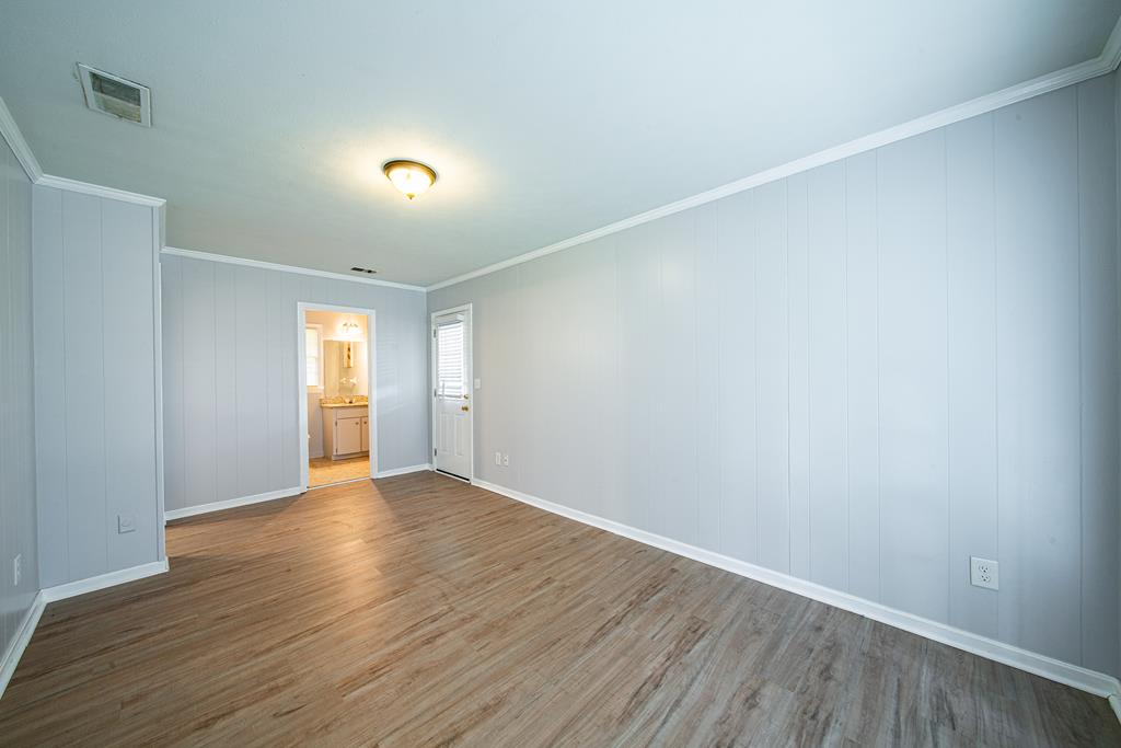 4 Clausen Drive Columbus, GA 31907 - Photo 16 of 27 an empty room with wooden floor and windows