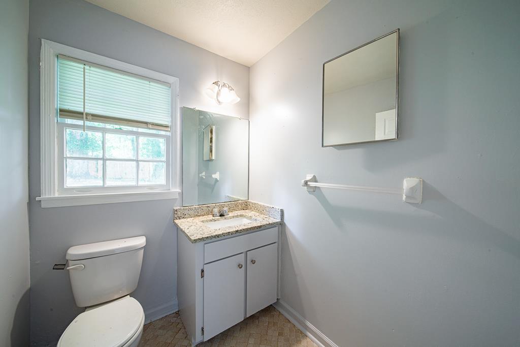 4 Clausen Drive Columbus, GA 31907 - Photo 17 of 27 a bathroom with a toilet a sink and a mirror