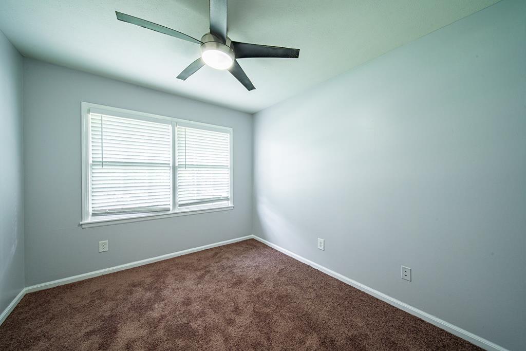4 Clausen Drive Columbus, GA 31907 - Photo 18 of 27 an empty room with a window and ceiling fan