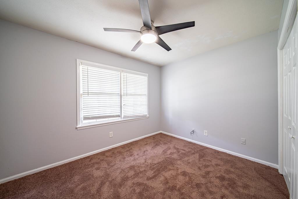 4 Clausen Drive Columbus, GA 31907 - Photo 23 of 27 an empty room with a window and a fan