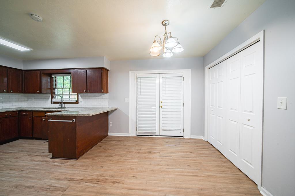 4 Clausen Drive Columbus, GA 31907 - Photo 6 of 27 a kitchen with stainless steel appliances granite countertop a refrigerator and a wooden cabinets