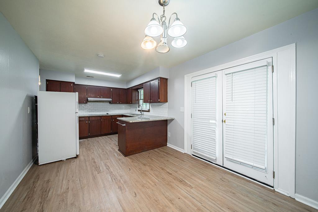 4 Clausen Drive Columbus, GA 31907 - Photo 7 of 27 a large kitchen with a wooden floor and stainless steel appliances