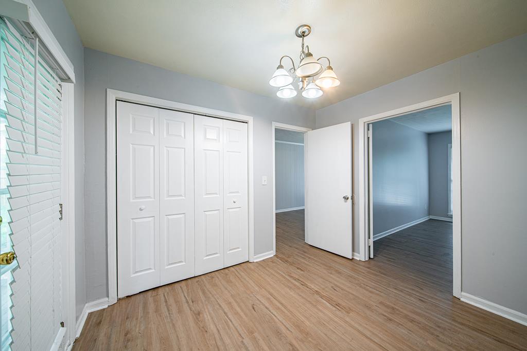 4 Clausen Drive Columbus, GA 31907 - Photo 8 of 27 wooden floor in an empty room with a window