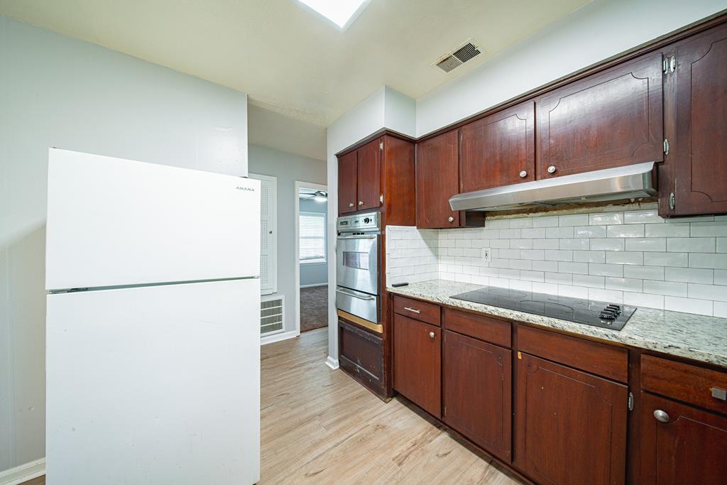 4 Clausen Drive Columbus, GA 31907 - Photo 10 of 27 a kitchen with stainless steel appliances granite countertop a refrigerator a sink and a stove