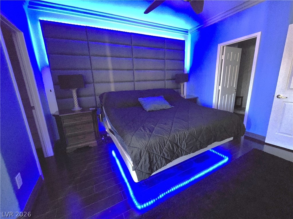 2050 West Warm Springs Road, Unit 2422 Henderson, NV 89014 - Photo 19 of 44 This primary bedroom features elegant crown molding and rich hardwood flooring.