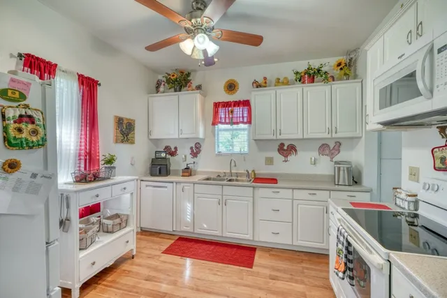 a kitchen with cabinets a sink and appliances