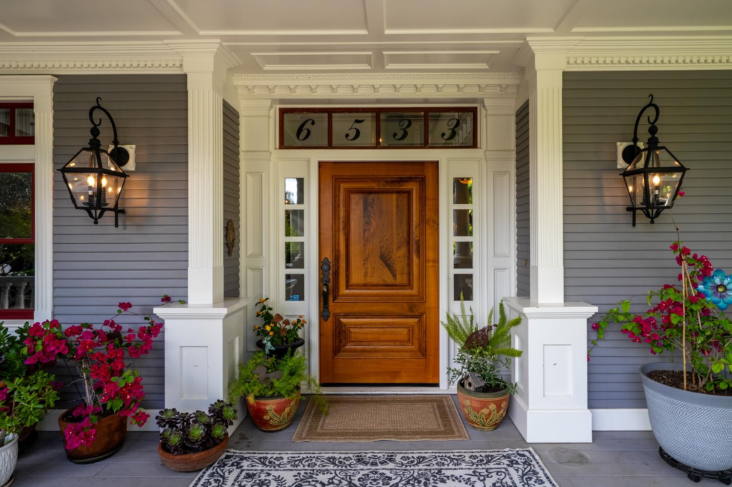 6533 Landis Avenue Carmichael, CA 95608 - Photo 13 of 77 Flanked by carriage lights, this cutom walnut door, hand crafted by Puente Construction is 3 3/4" thick. It makes quite a statement when entering the home.