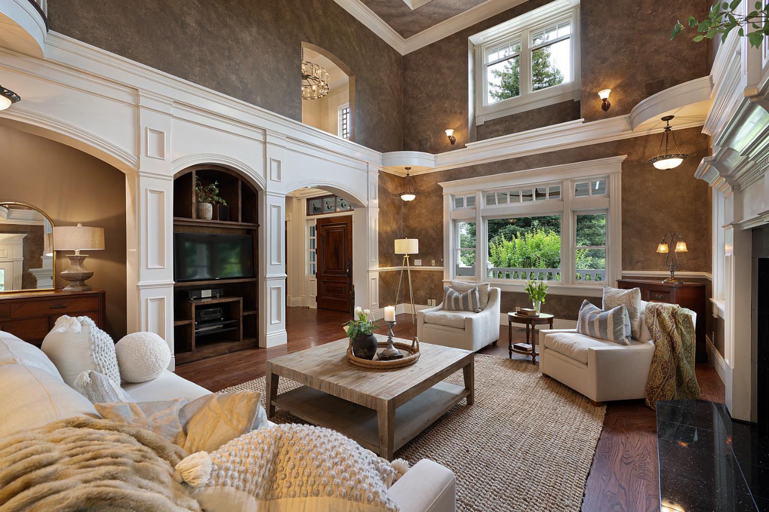 6533 Landis Avenue Carmichael, CA 95608 - Photo 17 of 77 The front room highlights classic Victorian style with detailed moldings, high ceilings, and warm hardwood floors. Tall double-hung windows bring in plenty of natural light, making the space feel bright and open. Soft lighting adds to the room’s charm, while front and side doors leads out to the wraparound front porch, creating an easy connection between indoor and outdoor living.