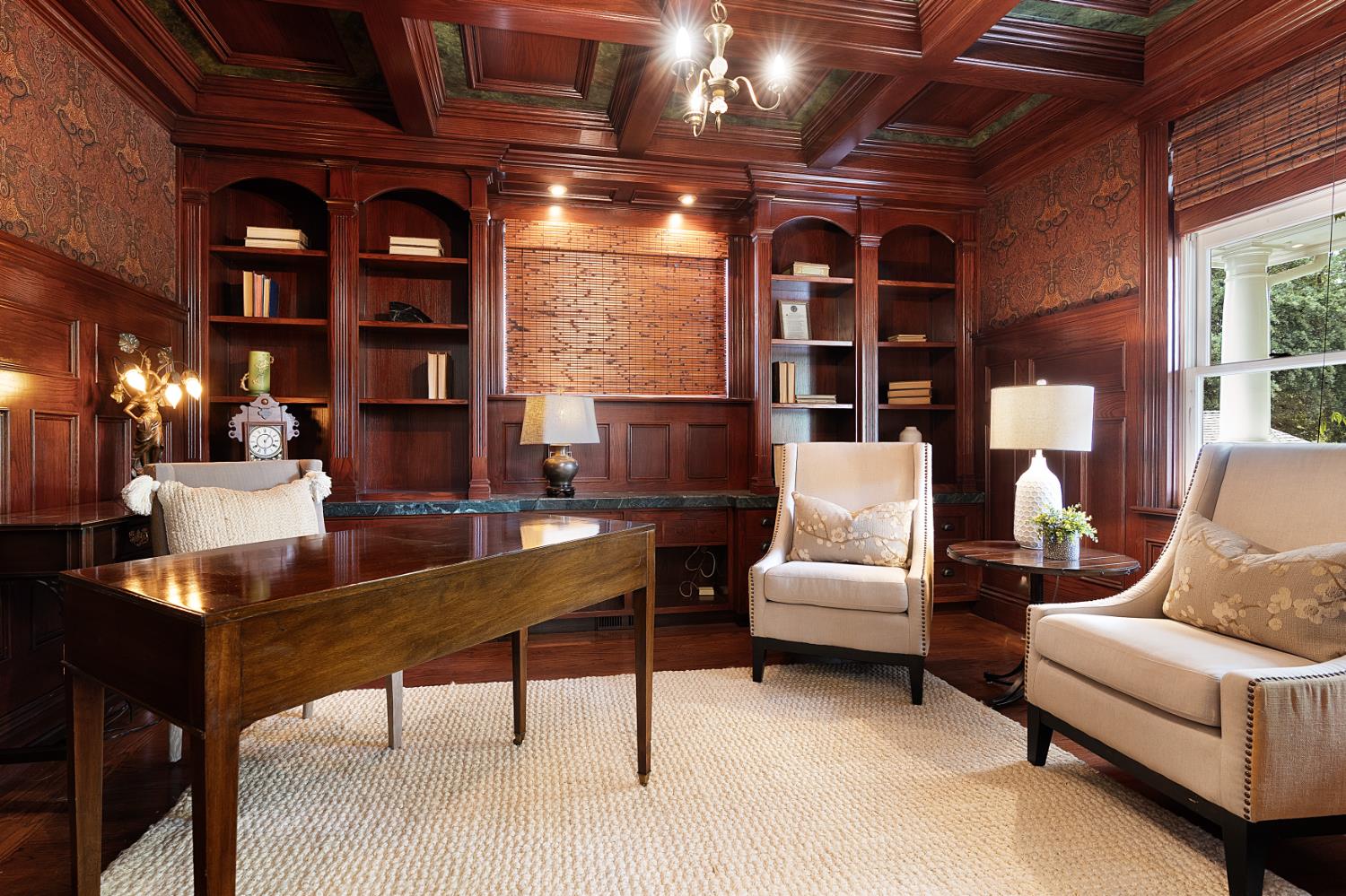 6533 Landis Avenue Carmichael, CA 95608 - Photo 20 of 77 This refined front office features glass-paneled French doors, rich hardwood flooring, and a White Oak box-beamed ceiling finished in mahogany stain, accented by faux-painted Italian marble inlays. Custom built-ins, Ralph Lauren wallpaper, a walk-in closet, and abundant windows combine to create a workspace that is both sophisticated and highly functional.