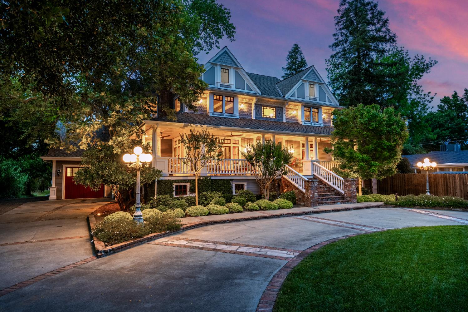6533 Landis Avenue Carmichael, CA 95608 - Photo 2 of 77 Inspired by classic Queen Ann Victorian architecture, 6533 Landis Avenue showcases an expansive wraparound front porch, perfect for quiet mornings or evening gatherings. Accented by carriage-style lighting and gently turning ceiling fans, steeply pitched roofline, graceful gables, and intricate decorative trim lend the exterior a sense of artistry and distinction, creating a truly captivating first impression. The pass-through 3-car garage is designed to show a single entry from the front and double entry from the rear.