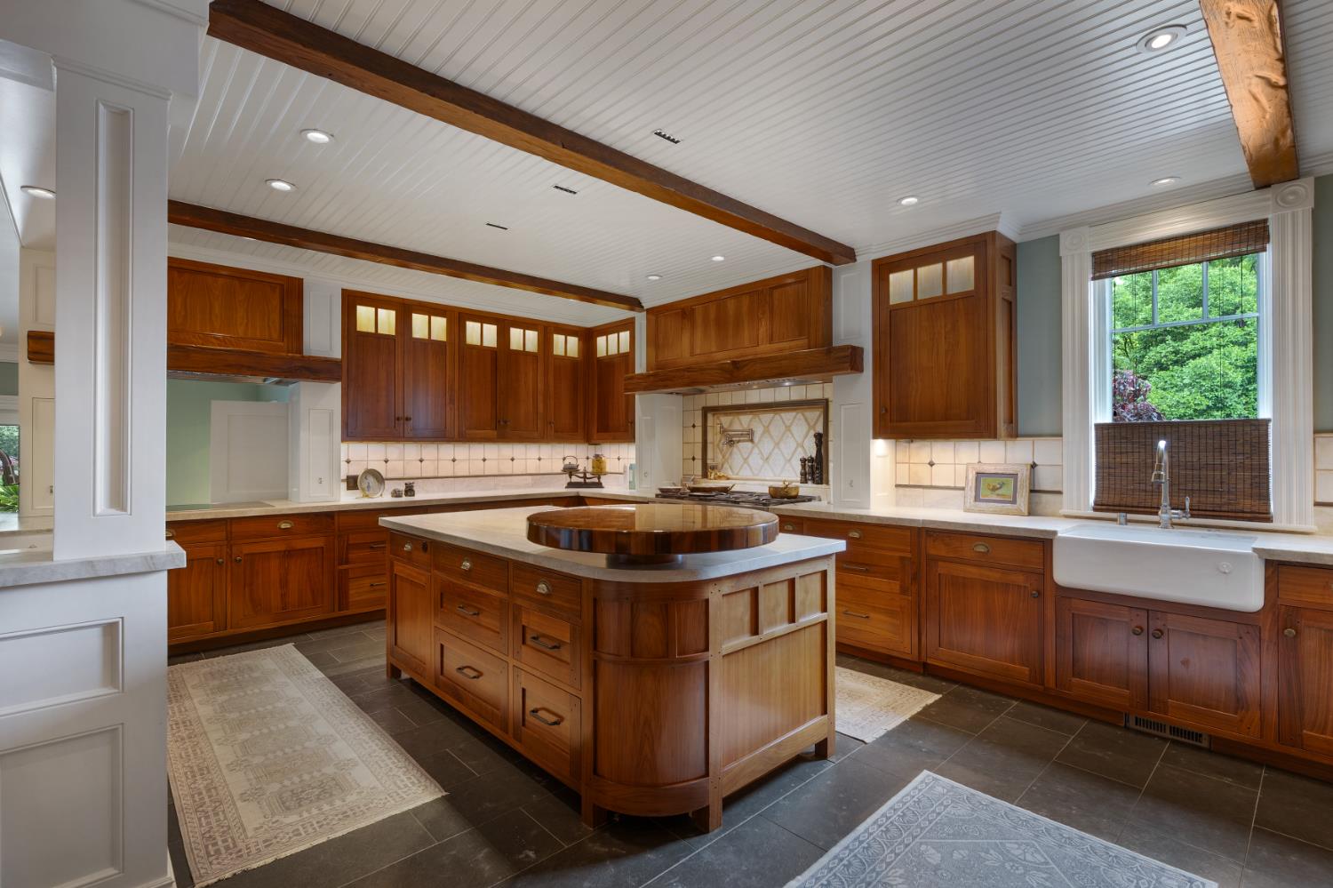 6533 Landis Avenue Carmichael, CA 95608 - Photo 26 of 77 Additional culinary features include an induction cooktop with professional ventilation, convection oven/microwave, convection steam oven, warming drawer, and a built-in espresso system, all designed for elevated everyday living and effortless entertaining. Two fully integrated dishwashers with matching walnut fronts and dual wine refrigerators further enhance functionality and sophistication.