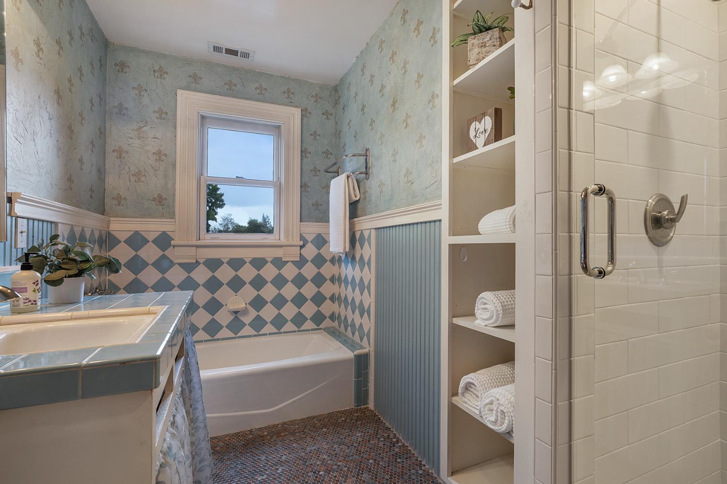 6533 Landis Avenue Carmichael, CA 95608 - Photo 49 of 77 This hall bath upstairs is decorated with whimsy and charm. The stall shower is newly tiled.