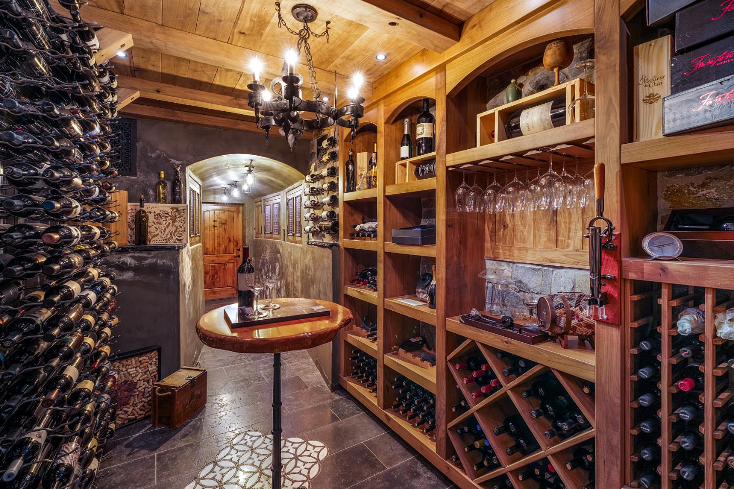 6533 Landis Avenue Carmichael, CA 95608 - Photo 54 of 77 The private wine cellar is a refined retreat designed for collectors, featuring authentic plaster and natural stone construction. It is climate-controlled to ensure ideal preservation conditions, with an impressive capacity to store approximately 1,000 bottles. Custom ambient lighting enhances the space, creating an intimate, gallery-like atmosphere that showcases the collection beautifully.