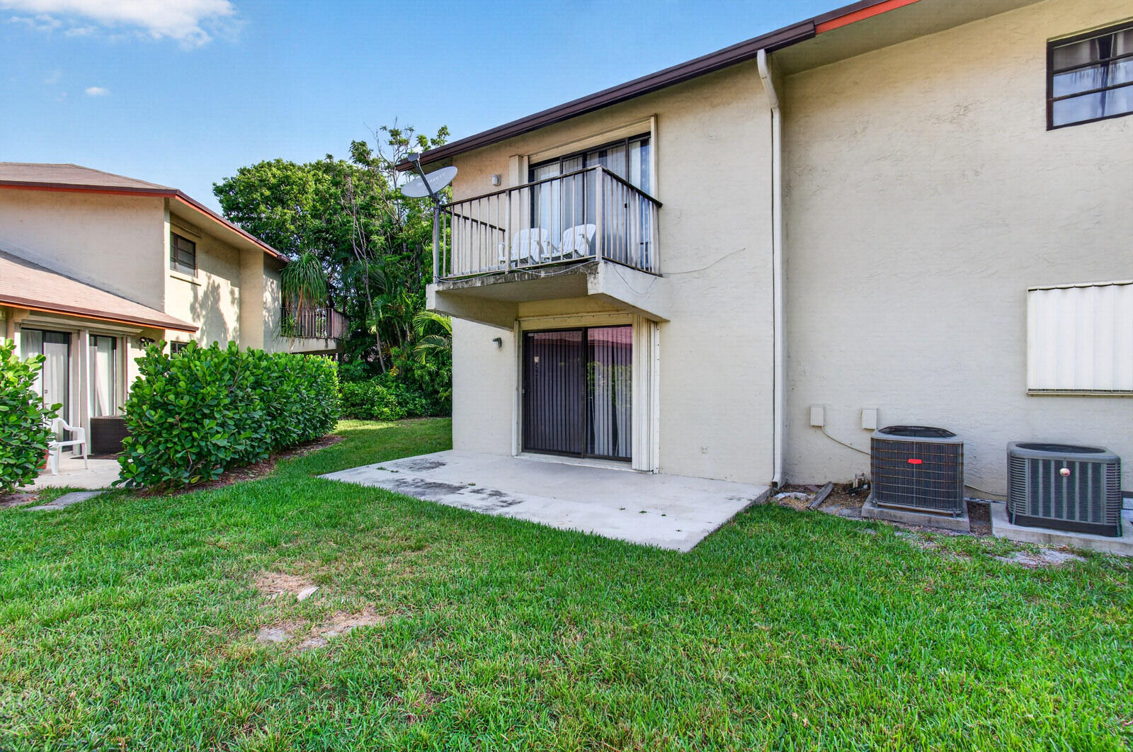 3951 Northeast 19th Road, Unit 1701 Pompano Beach, FL 33064 - Photo 81 of 82 a front view of a house with garden and plants