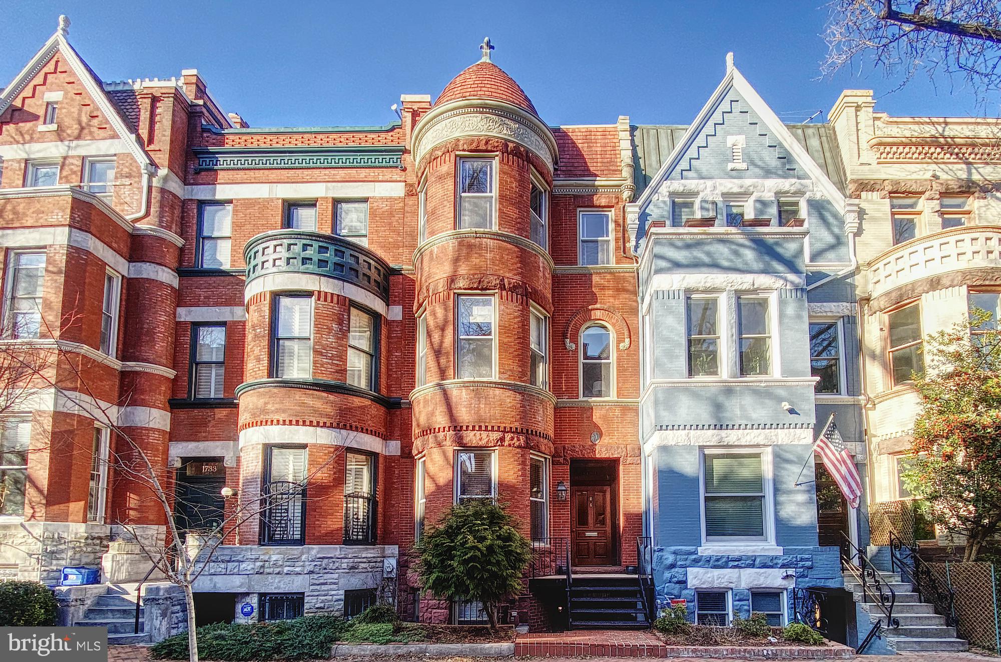 a view of a brick building next to a yard